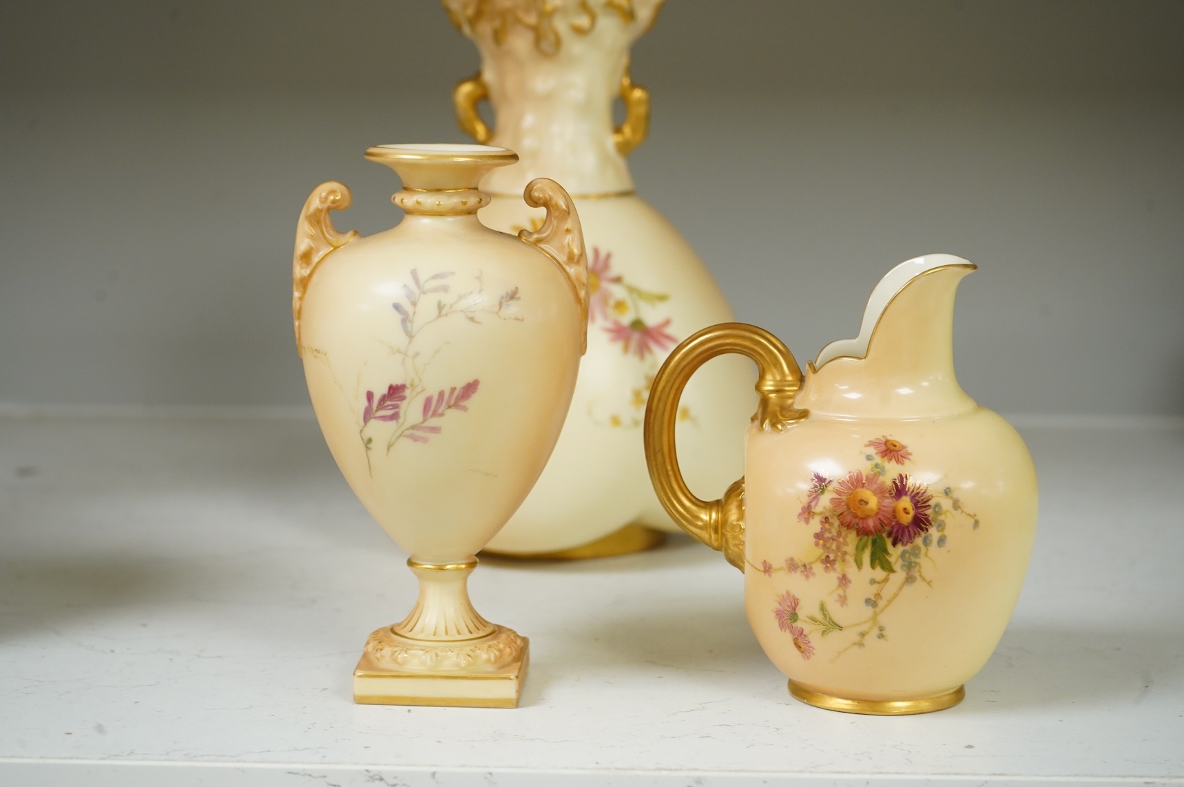 Three pieces of Royal Worcester blush ivory porcelain vessels, tallest 20cm